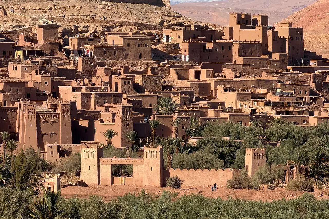 Earthen houses and towers of the Ksar of Ait Ben Haddou above palm groves