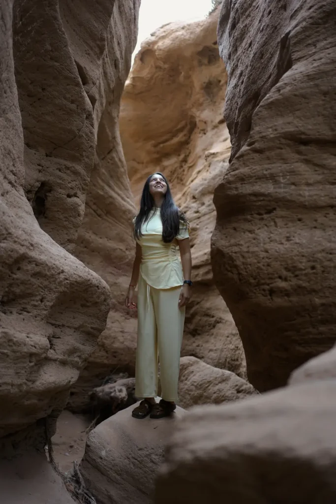 Visitor in a narrow sandstone canyon near the Timlalin dunes